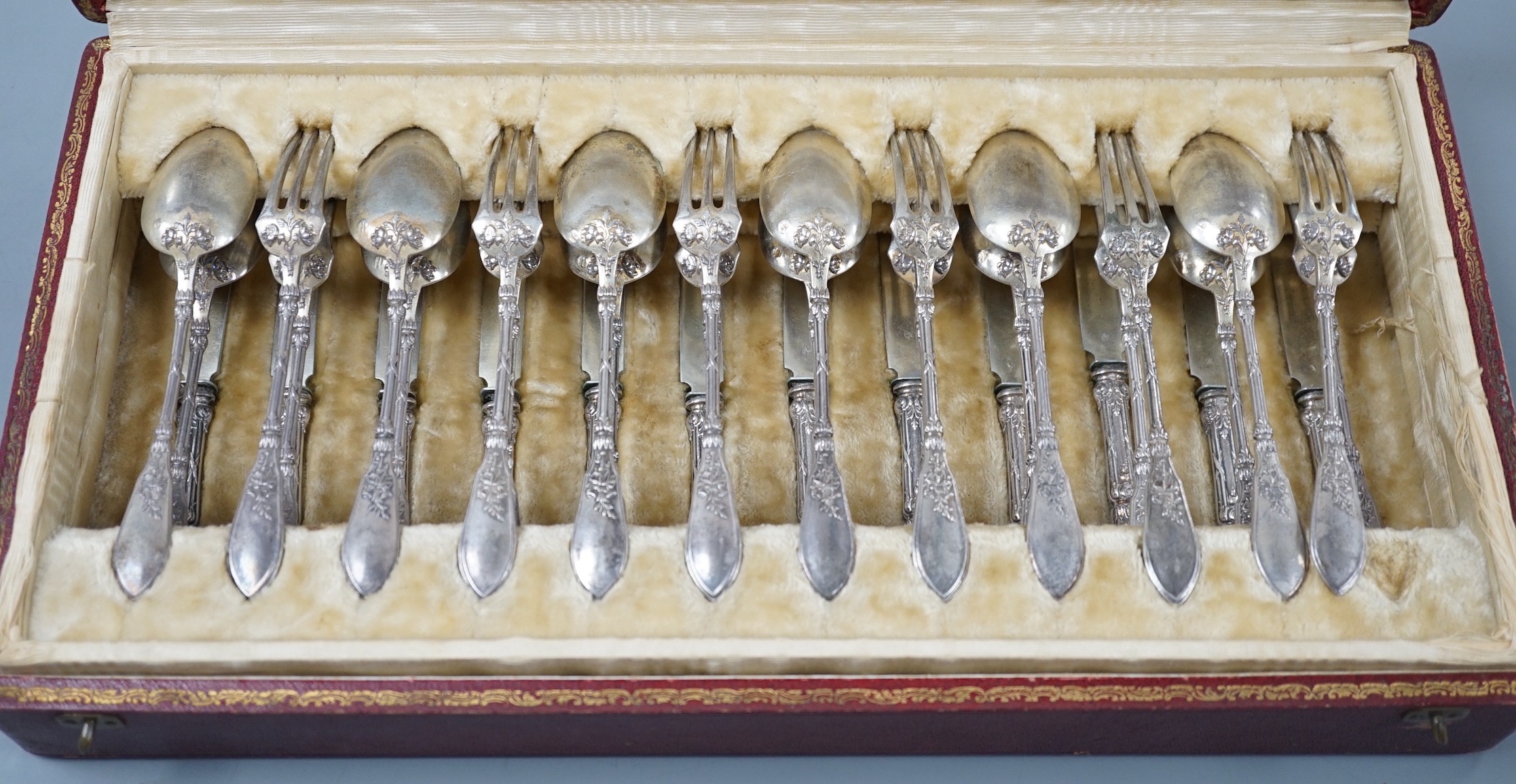 An early 20th century cased set of twelve French 950 standard white metal tea knives, spoons and forks, by Henin & Vivier and Henin & Cie?, retailed by Charles Pellegrin, spoon 14.1cm, 20oz.